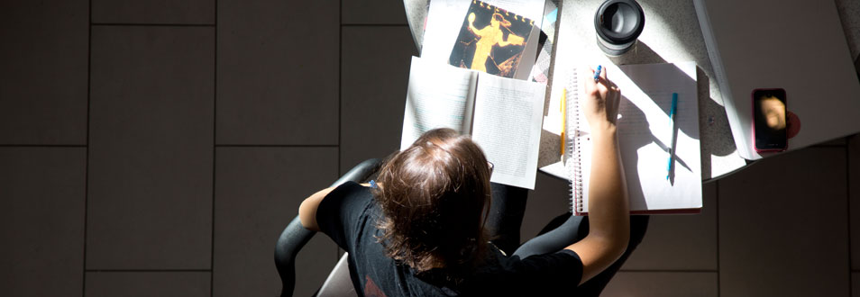 Student laboring over a notebook