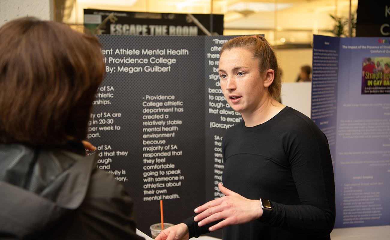 A PC student presents a poster on Student-Athlete mental health
