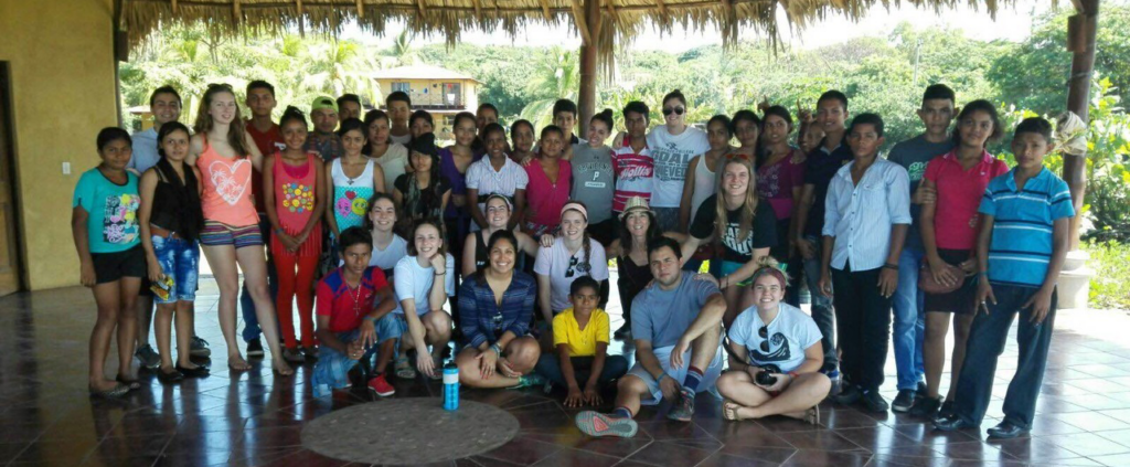 Group shot of Global Education and TESOL graduate students with children